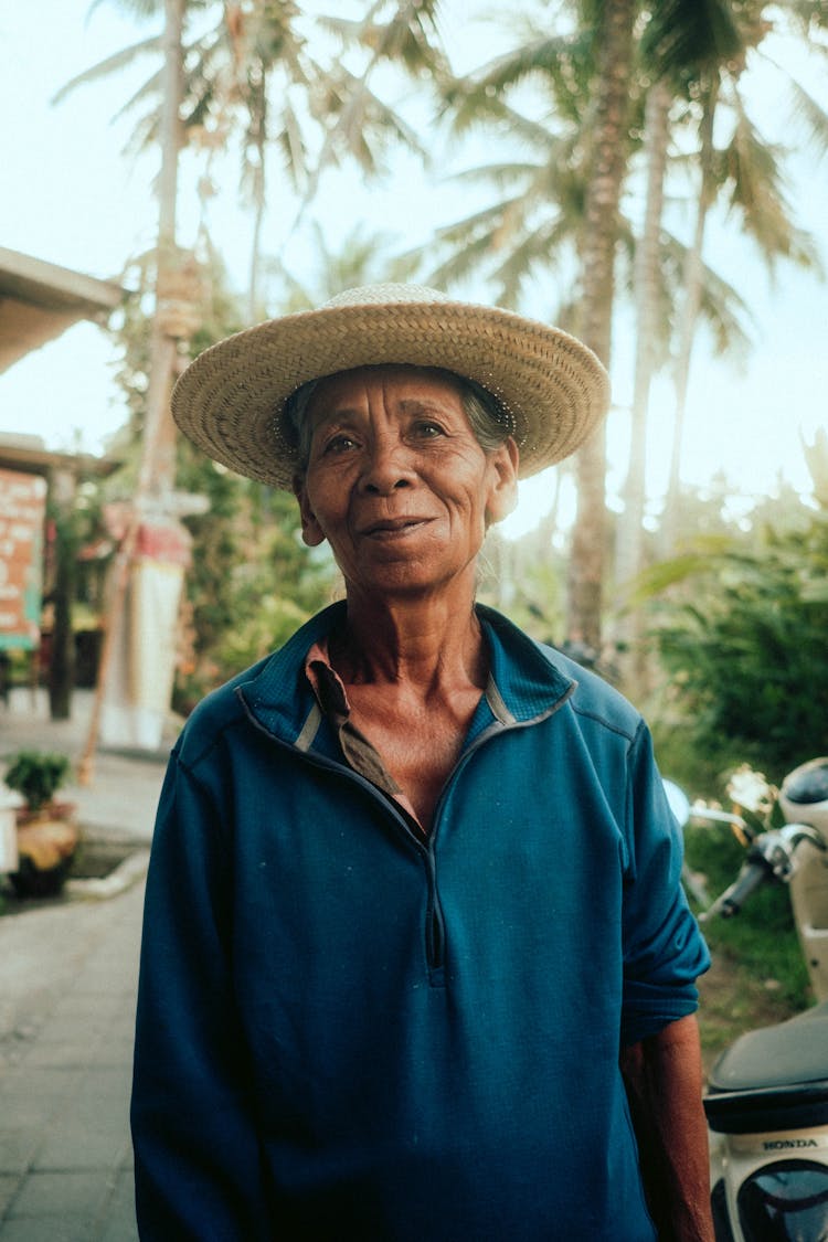 Senior Woman In Straw Hat And Blue Fleece