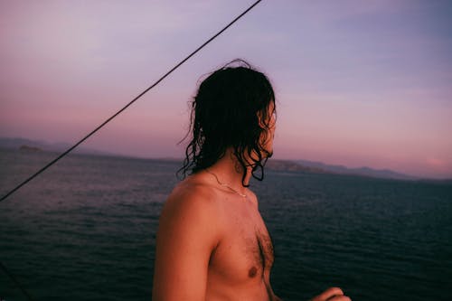 Bare Chested Man Looking at the Sea
