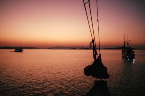 Ships Sailing on Sea at Sunset