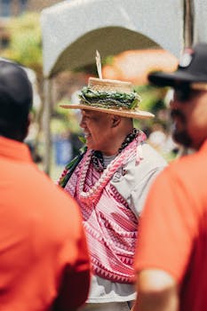 Man in traditional costume enjoying a vibrant outdoor cultural festival.