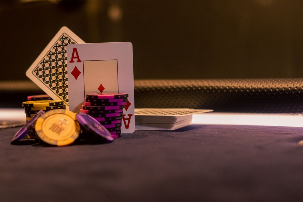 Close-up of poker chips and an ace of diamonds playing card on a casino gaming table