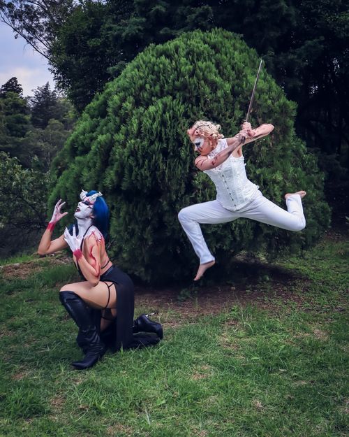 Free Two cosplayers engaged in a dramatic pose, showcasing dynamic costumes and makeup. Stock Photo