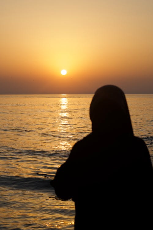 Silhouette of Woman During Sunset on a Beach