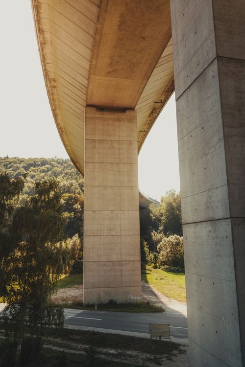 Free View of a concrete bridge surrounded by lush forestry in Edlitz, Austria, highlighting modern infrastructure. Stock Photo