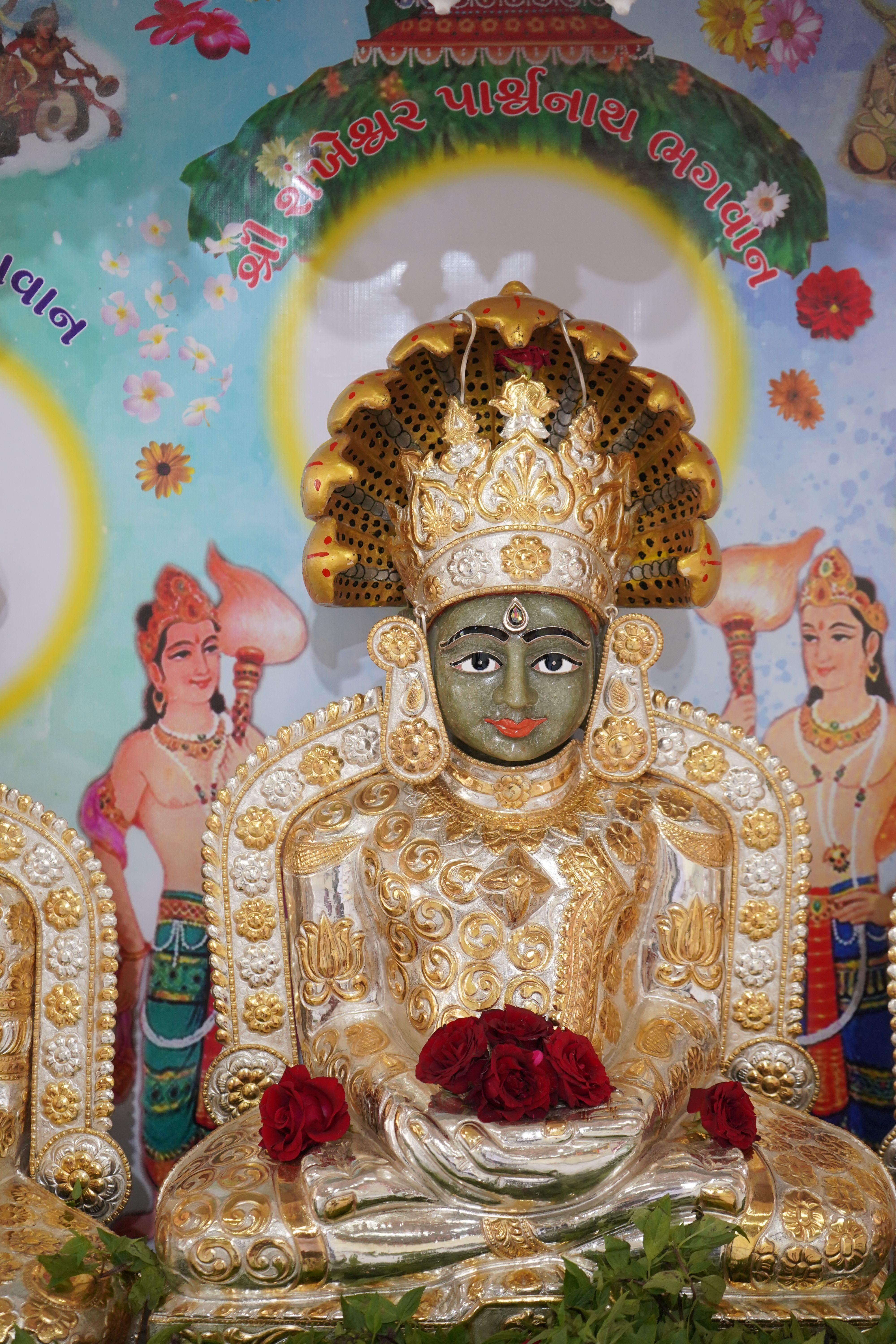 A beautifully adorned religious statue with traditional attire and symbolic ornaments, exemplifying cultural and spiritual artistry.