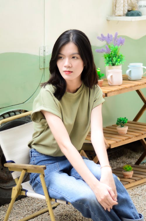 Woman with Black Hair Sitting on Chair