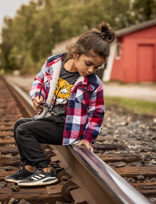 Girl Sitting on Railway Track