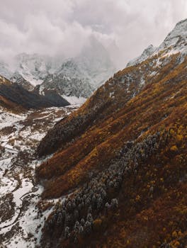 Breathtaking aerial view of snowy mountains in Karachayevsky District, Russia.