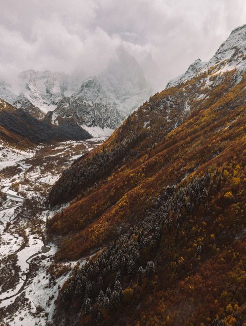 Breathtaking aerial view of snowy mountains in Karachayevsky District, Russia.