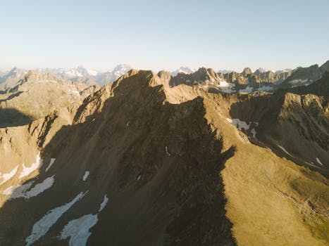 Drone shot of the dramatic Caucasus Mountains in Karachay-Cherkessia, Russia during daylight.