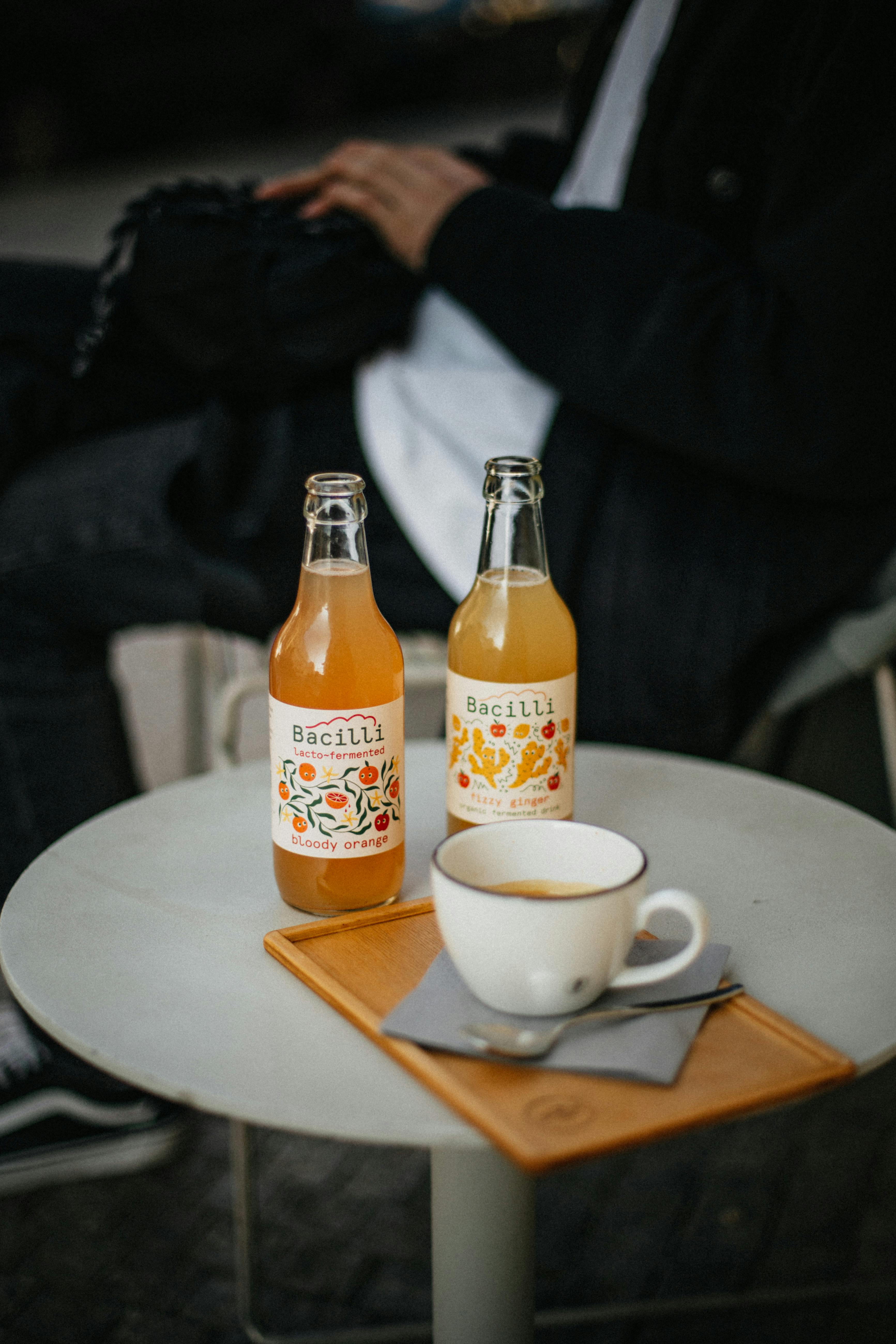 Bottled refreshments with a coffee cup on a cafe table in Prague