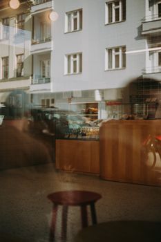 A cozy café interior with street reflections of Prague, capturing the city's urban vibe.