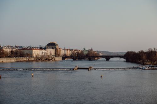 Free Panoramic view of Prague with the Vltava River and historic architecture under a clear sky. Stock Photo