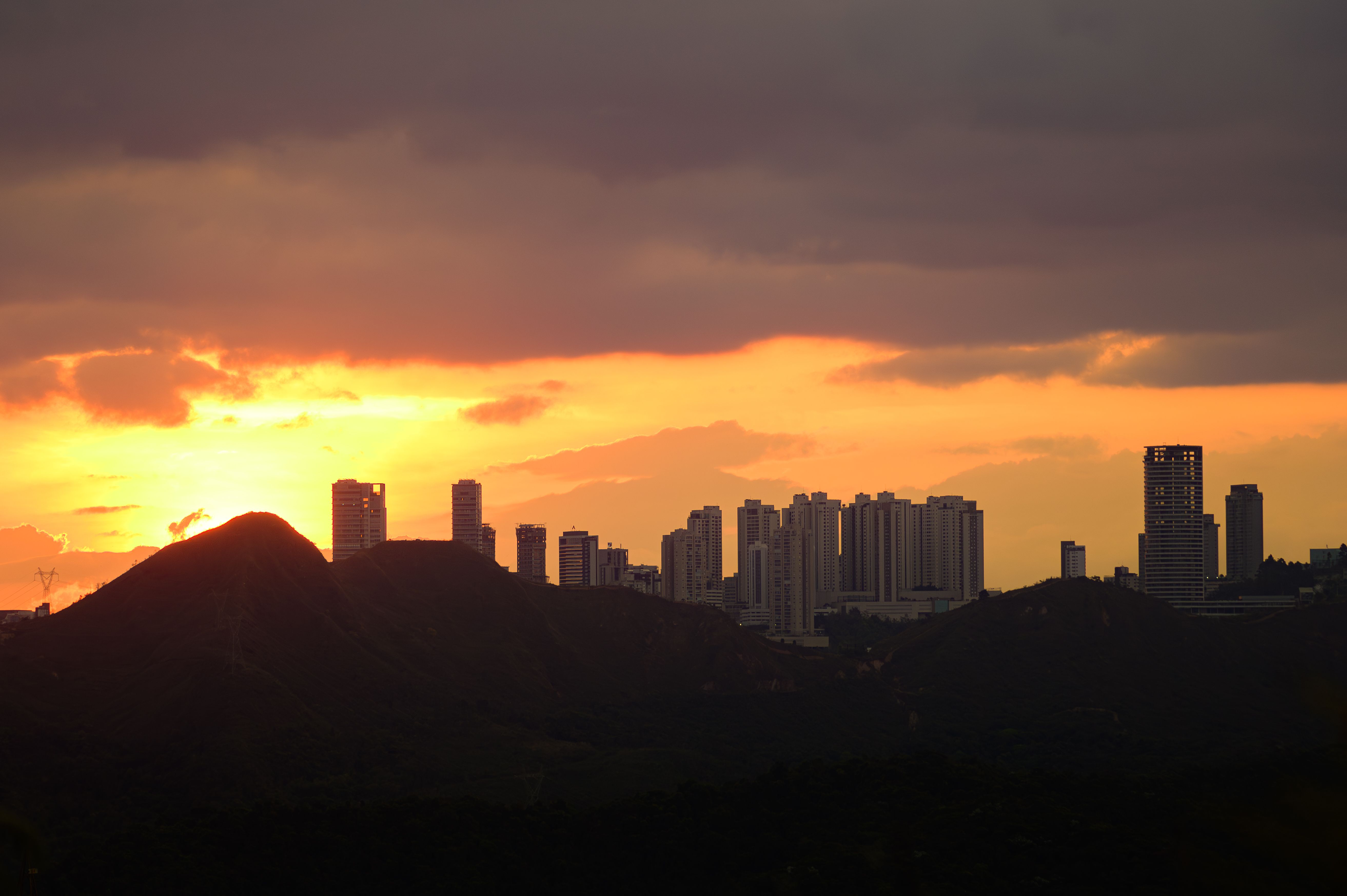 Sunset Over the City Behind the Hills · Free Stock Photo