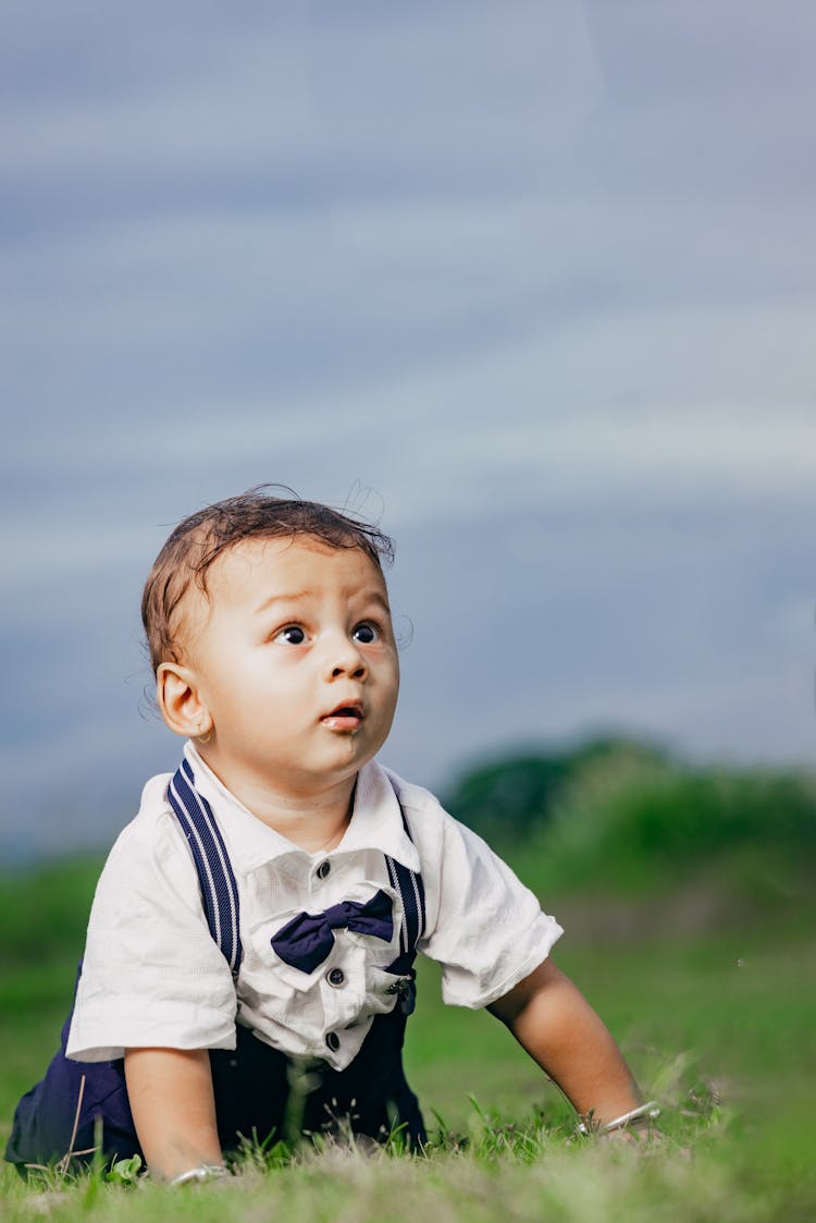 Baby Boy Lying Down On Ground