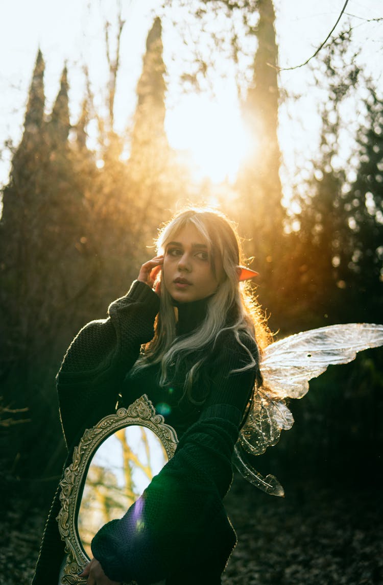 Woman In A Costume Holding A Mirror 