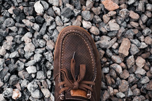 Shoe On Rock Pebbles