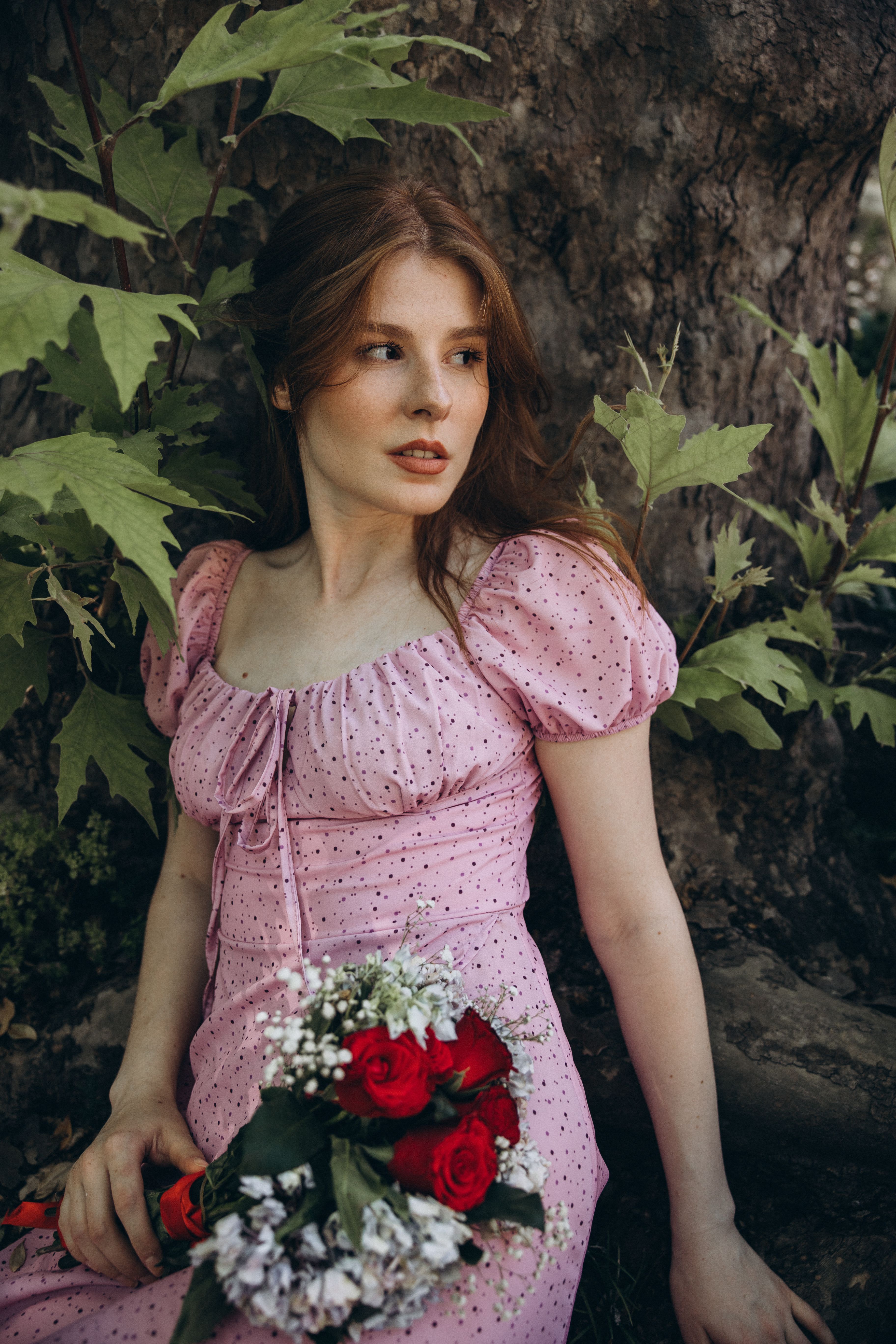 Elegant Woman in Pink Dress Holding Flowers Outdoors · Free Stock Photo