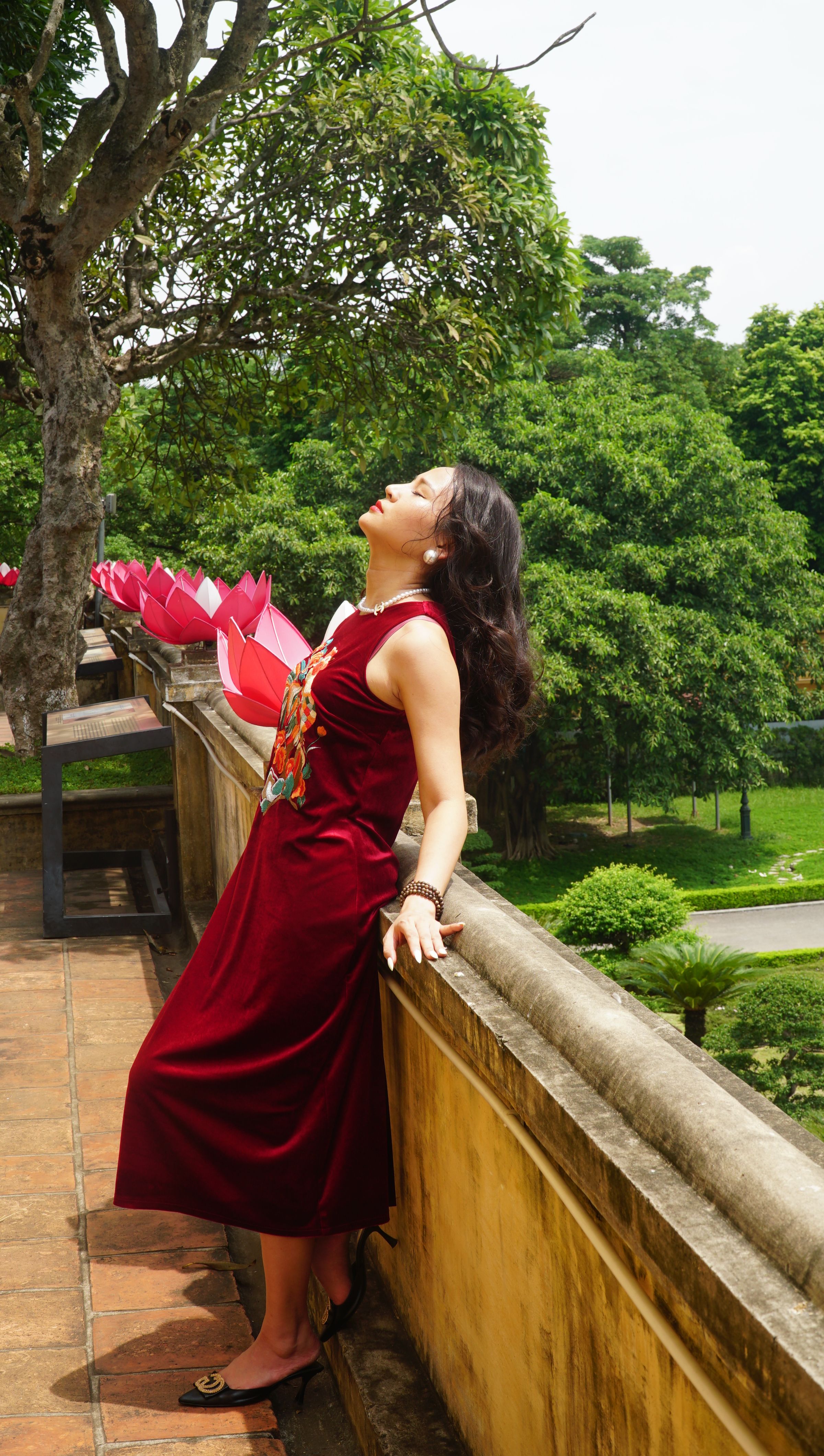 Woman in Red Dress Posing by Wall in Park · Free Stock Photo