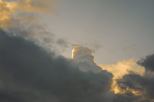 Captivating sunset with dramatic clouds and warm light shining through.
