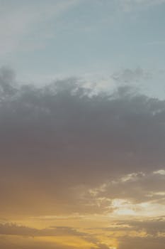 A beautiful sunset with dramatic clouds and warm hues creating a peaceful atmosphere.