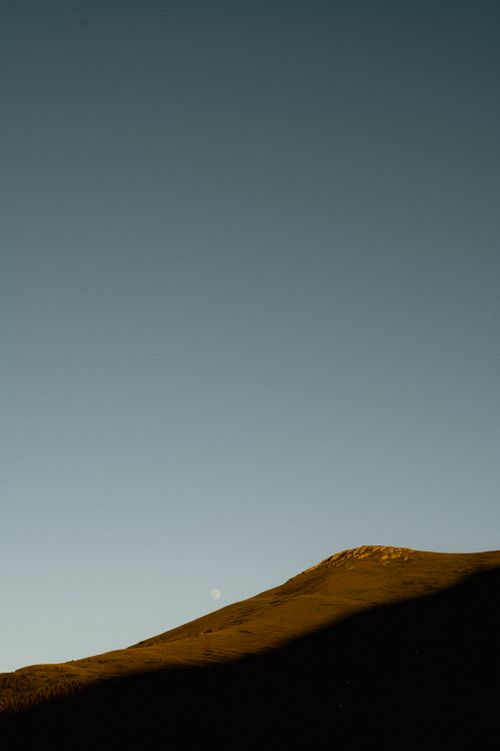 Free A stunning mountain peak at sunrise with shadows creating a dramatic effect against a clear sky. Stock Photo