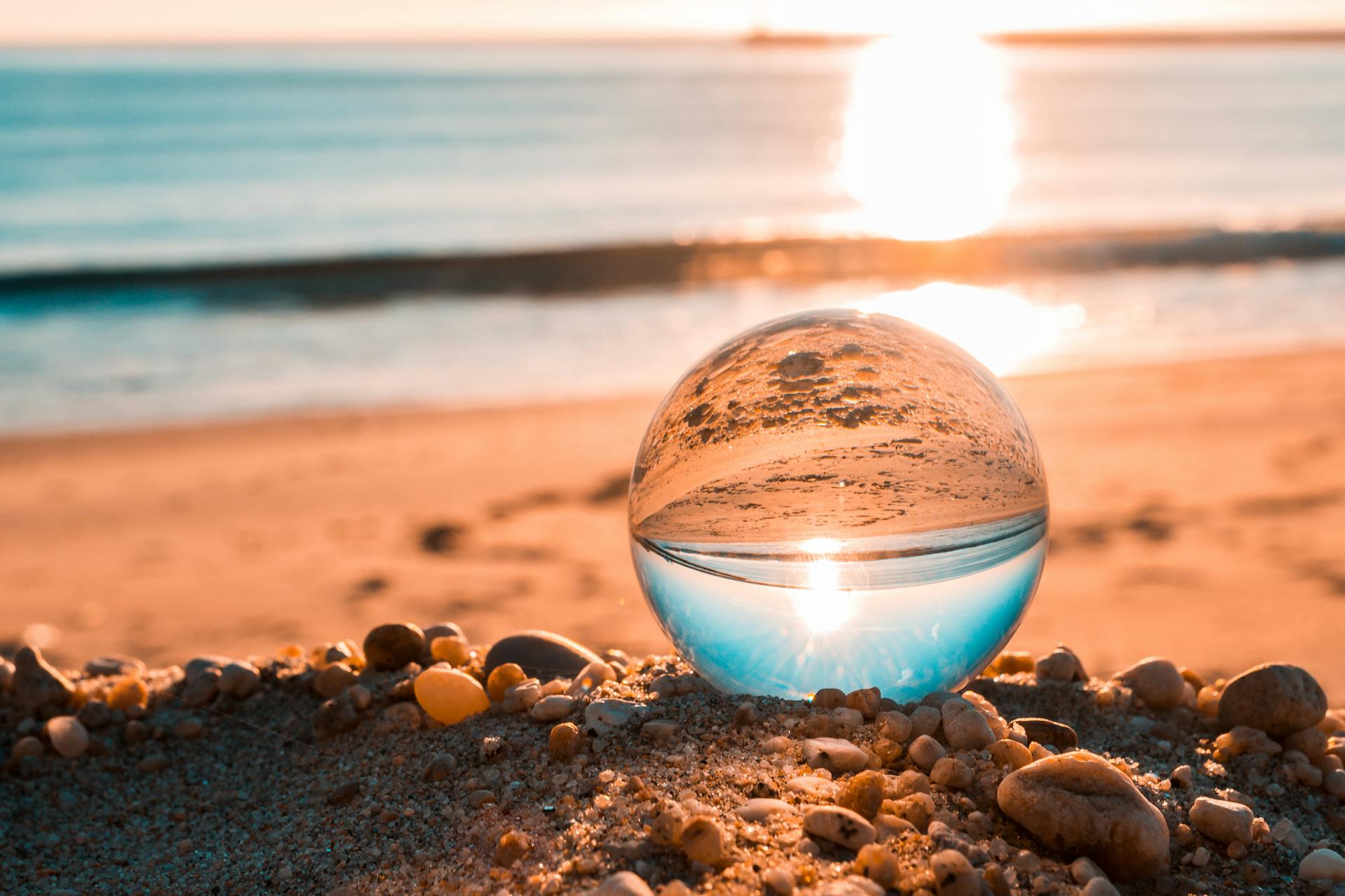 Clear Glass Ball on Brown Sands