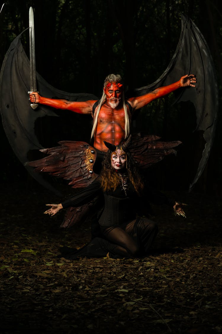 Dark Photo Of A Man And A Woman In Demon Costumes