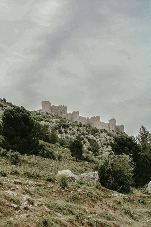 Free Explore the enchanting chateau ruins atop a verdant hill in France. Stock Photo