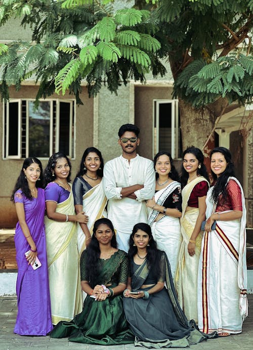 Smiling Young Women in Saris with Man