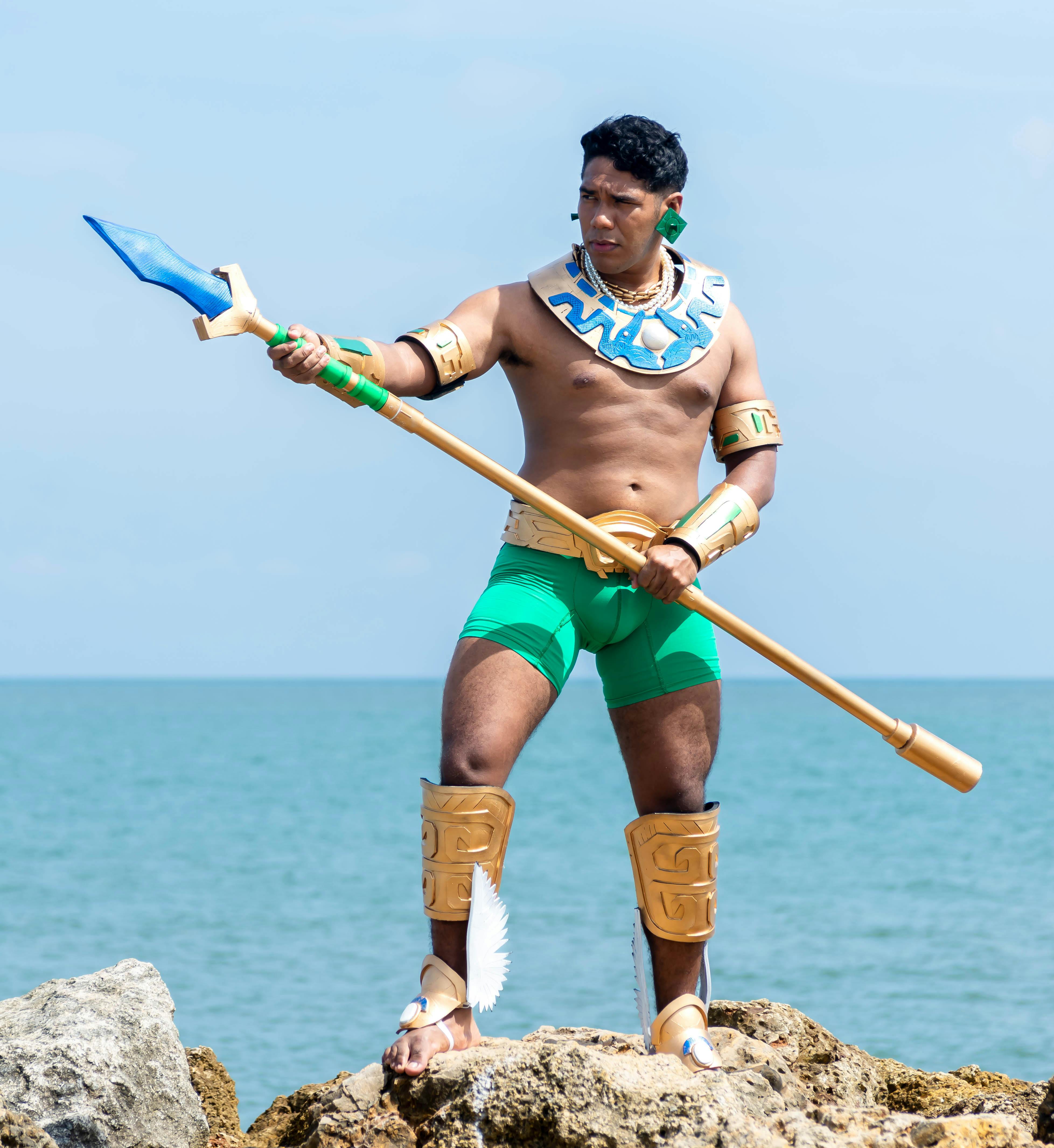 man in a native costume standing on a cliff