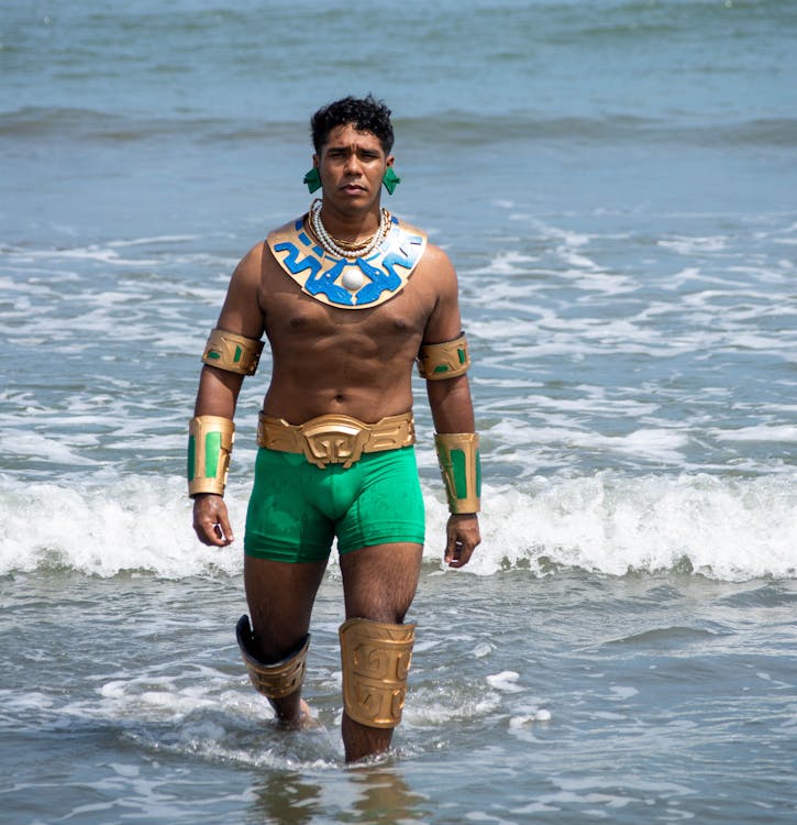 Man Wearing a Superhero Costume Walking in Coastal Water · Free