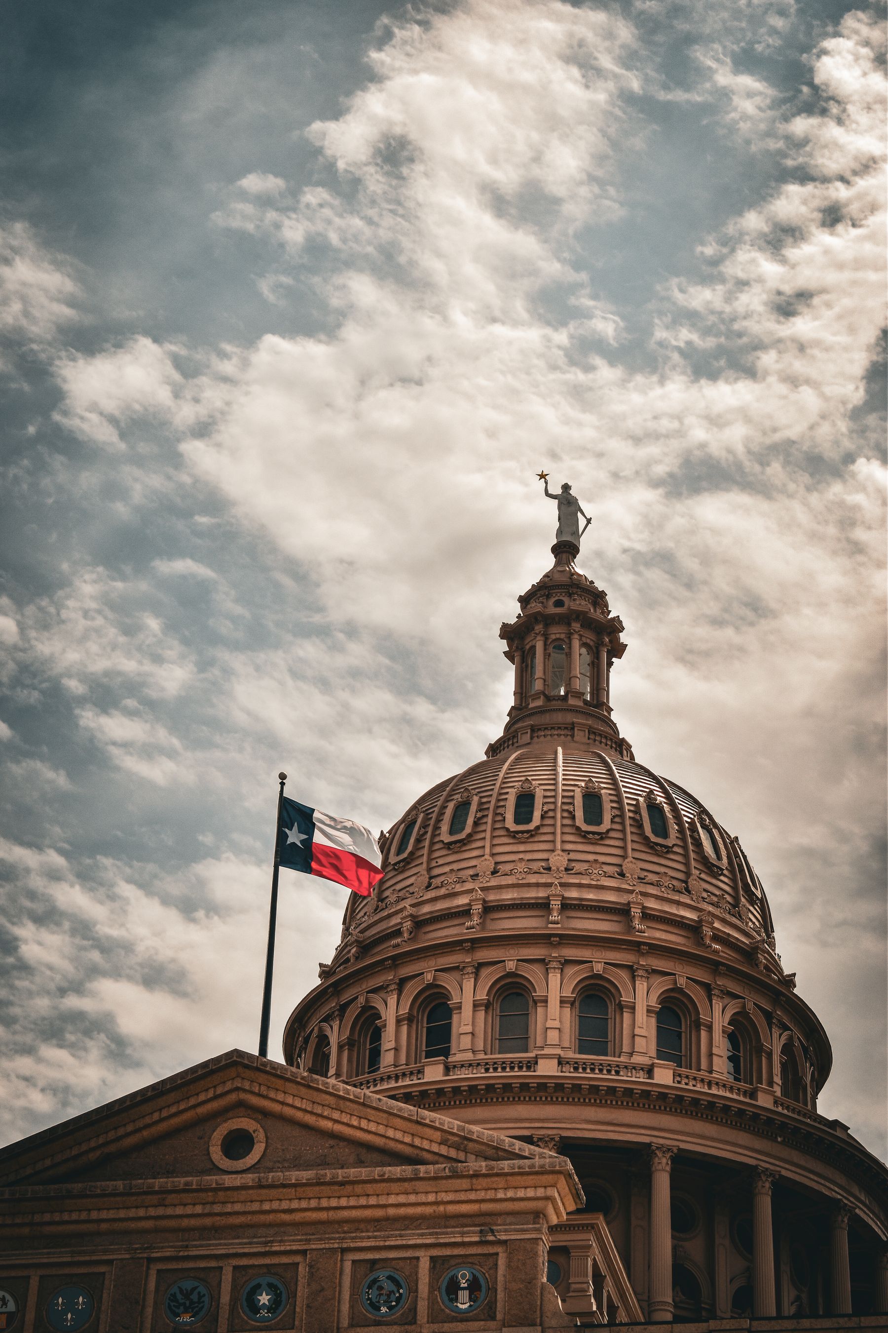 The Texas State Capitol dome with the Texas state flag in Austin