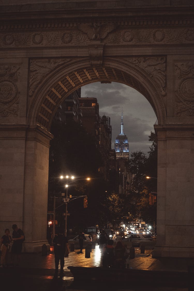 Street And Empire State Building Behind Arch In New York