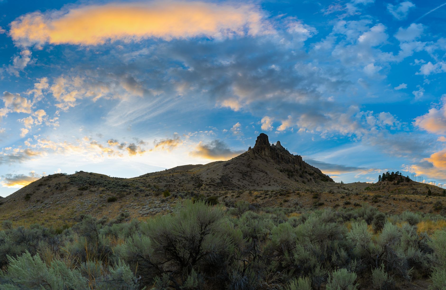 Beautiful sunset view with dramatic clouds over hills in West Wenatchee, WA, USA.