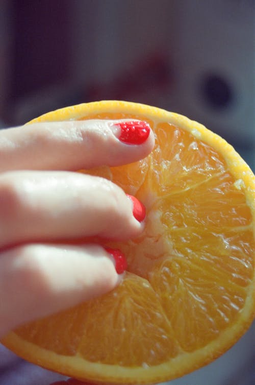 Woman Fingers on Fruit Slice