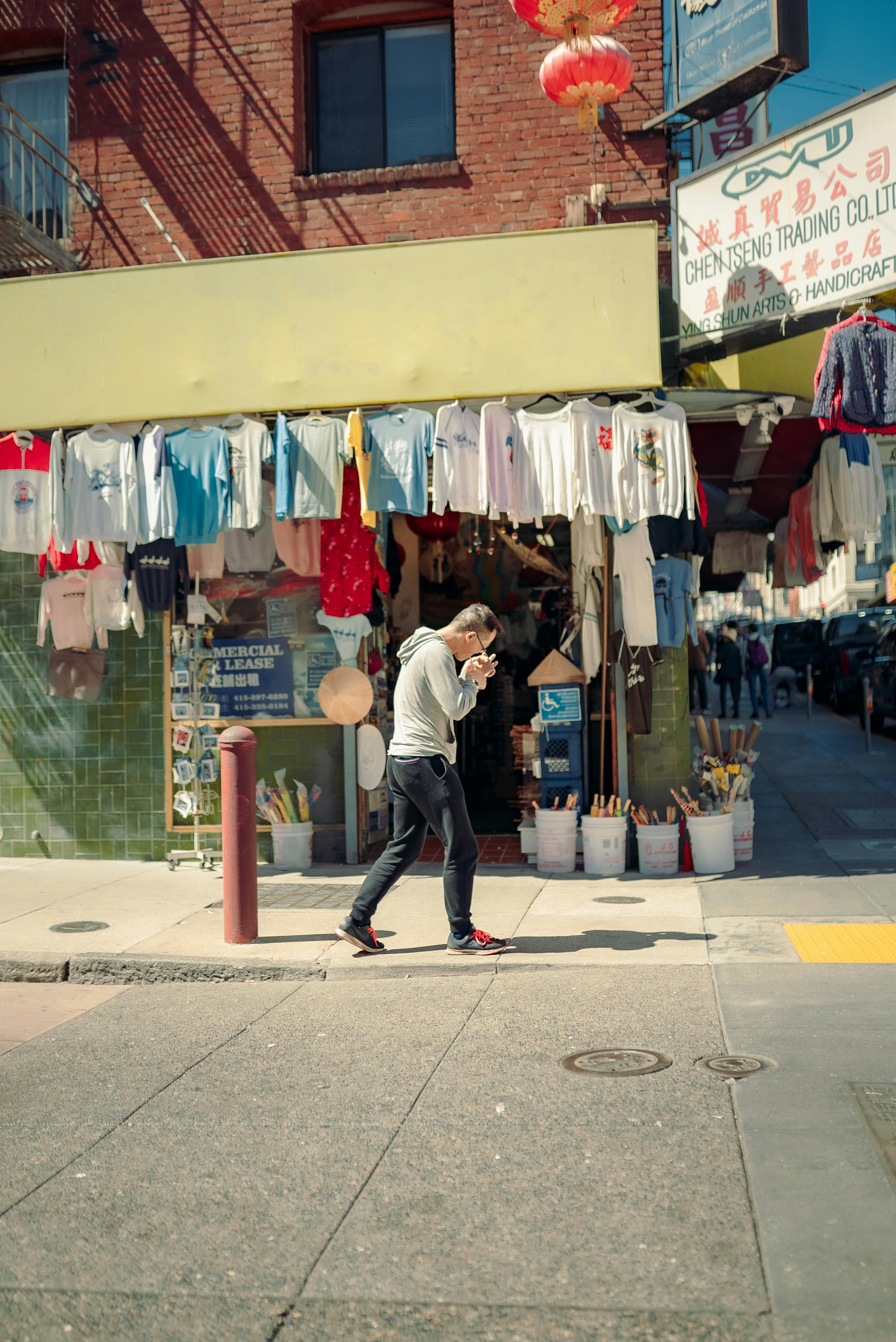 man walking near clothes store