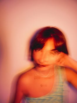 Creative portrait of a young woman with motion blur effect in warm tones.