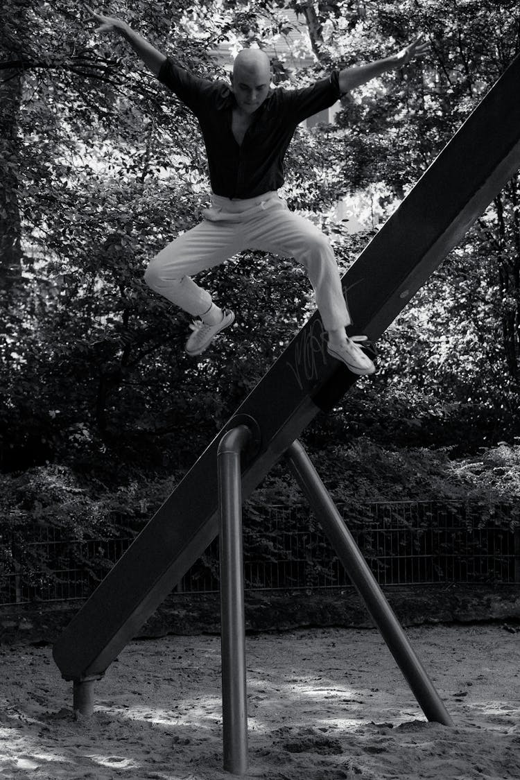 Bald Man Jumping In Park