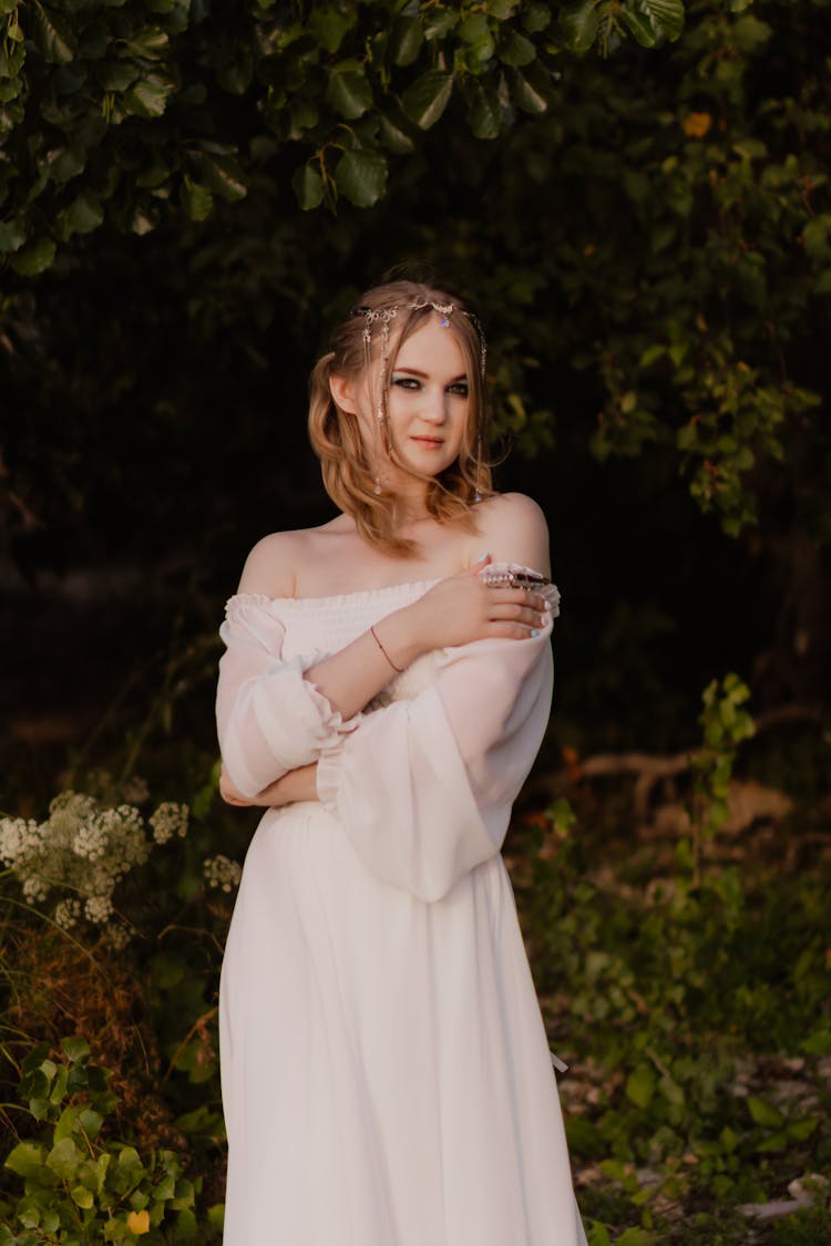 Cute Young Woman In A Wedding Dress Standing In The Garden