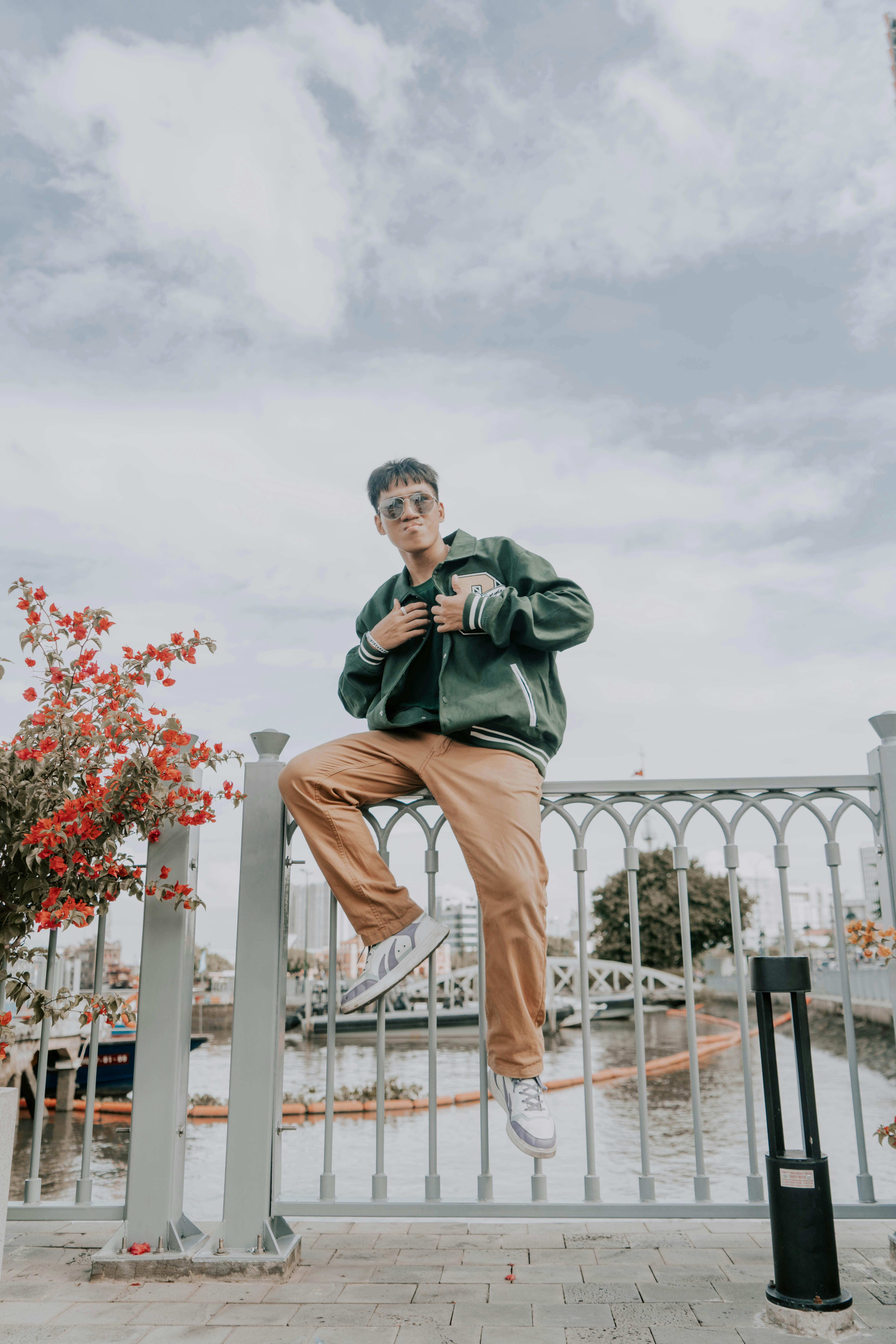 Free Stylish young man posing by a city canal in Ho Chi Minh City, Vietnam. Stock Photo