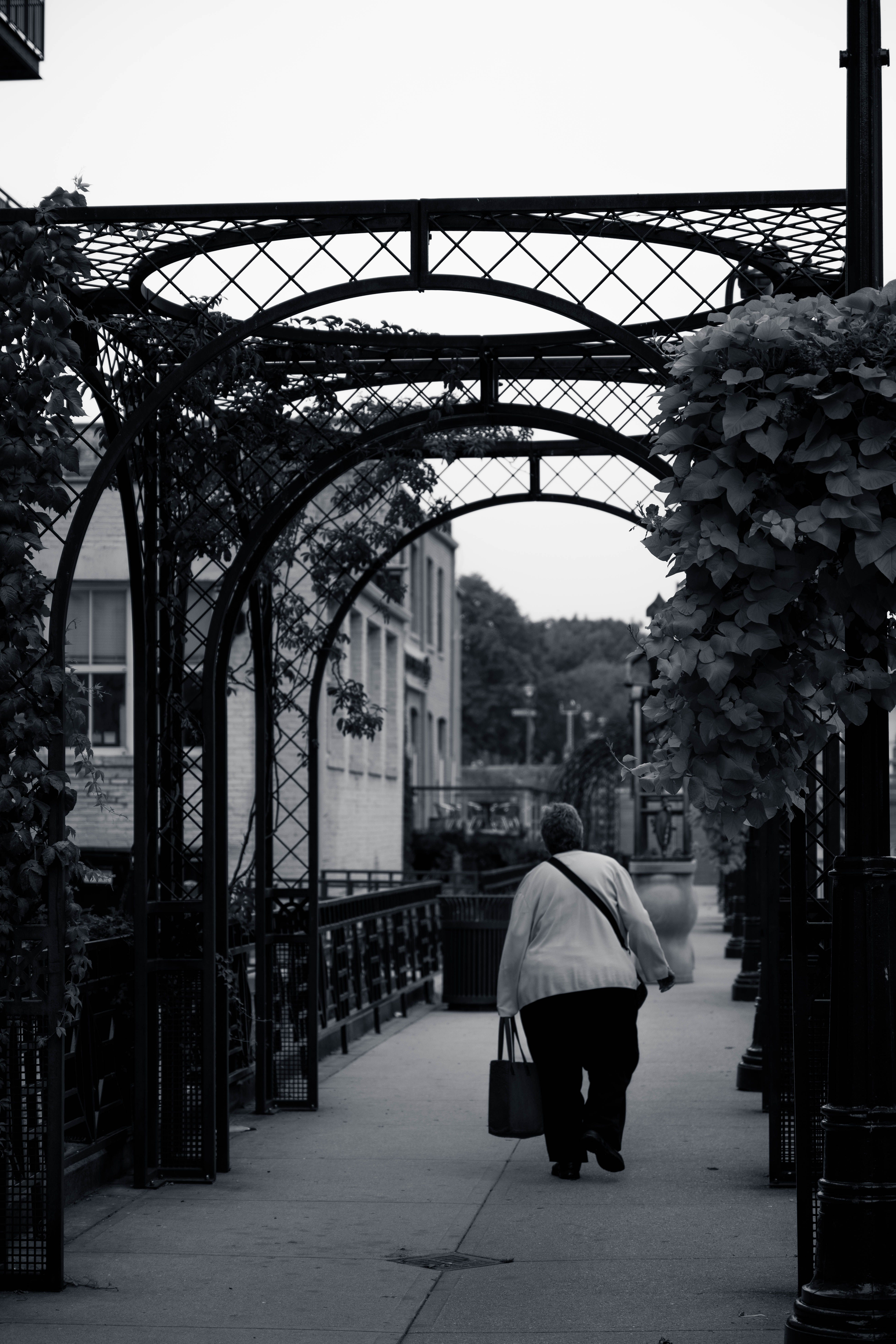 Elderly Woman Walking on the Sidewalk · Free Stock Photo