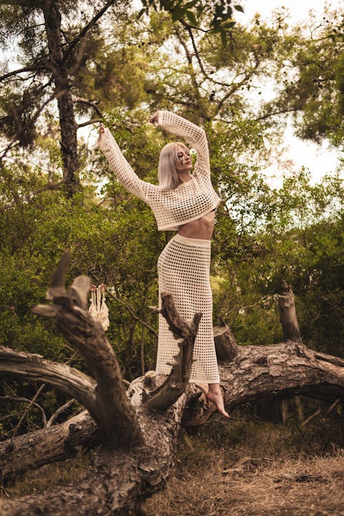 Woman in a White Outfit Posing in the Forest