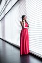 Woman in Pink Dress Standing Near Window