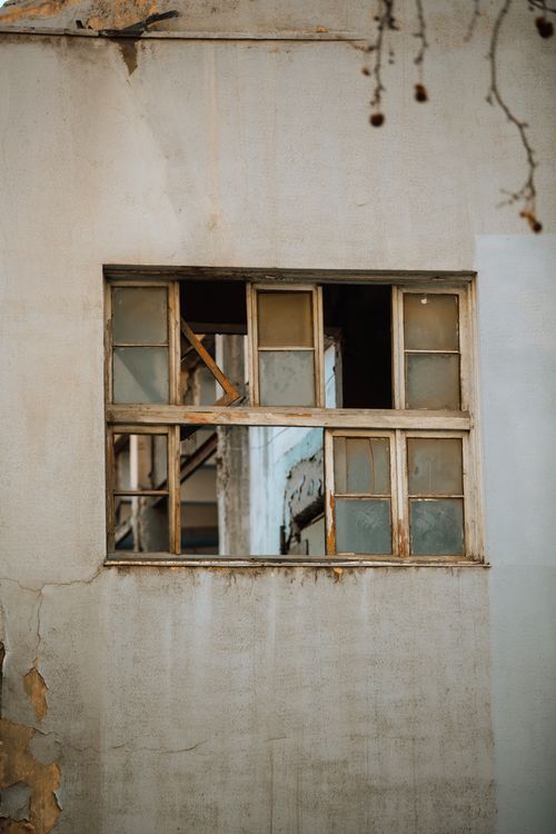 Free Old and weathered window on a rundown building facade in Baku, Azerbaijan. Stock Photo
