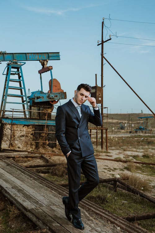 Man in a Suit Walking on a Construction Site