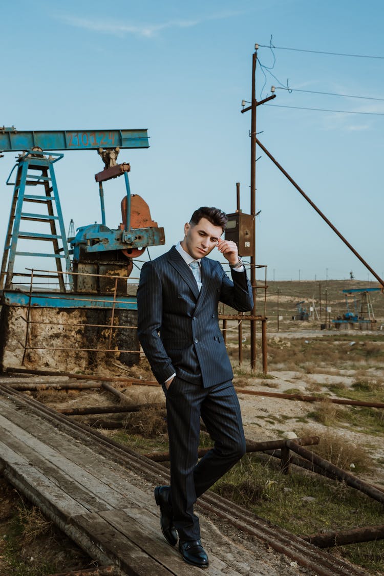 Man In A Suit Walking On A Construction Site