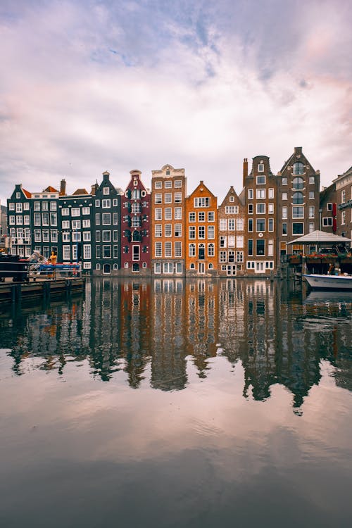 Colorful Houses by Canal in Amsterdam, Netherlands