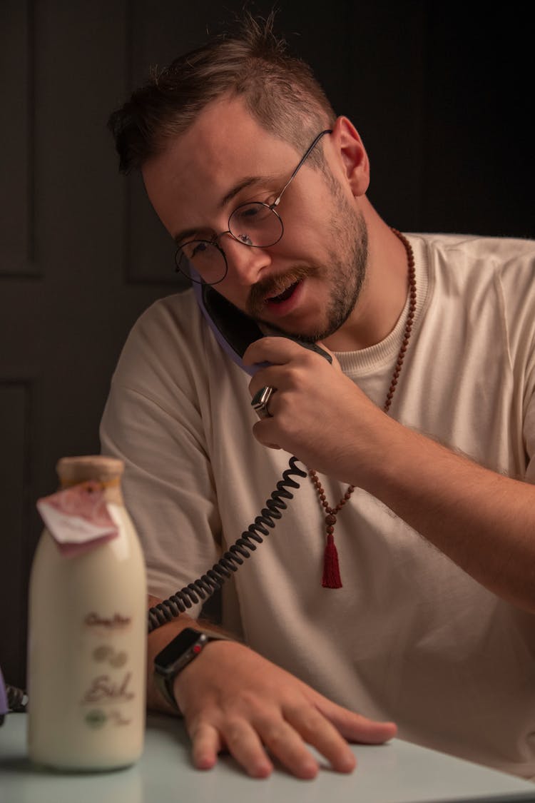 Man Talking On A Landline Phone