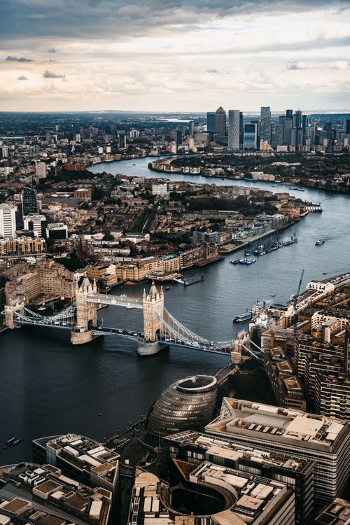 Free Stunning aerial shot of London's skyline highlighting Tower Bridge and the River Thames. Stock Photo